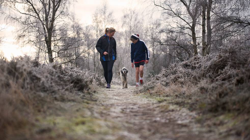 family walking dog in winter